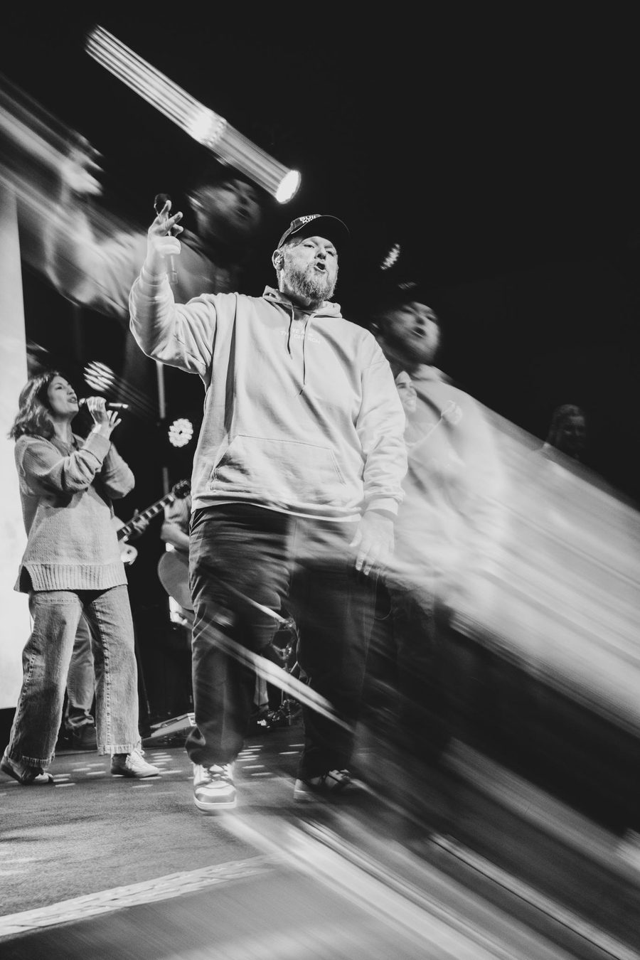 Ryan Spoon on stage with a worship team